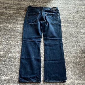 Levi black tag zipper back pockets